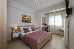 a bedroom with a large bed and a window at Galanthus Apartment 2 in Chania