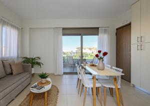 a living room with a table and chairs and a couch at Galanthus Apartment 2 in Chania