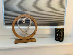 a wooden ring sitting on a window sill next to a candle at Zwei Apartments - ein Haus - Alles fußläufig - Altstadt, Wanderwege, Freibad und Restaurants in unmittelbarer Nähe in Schmallenberg +67 photos