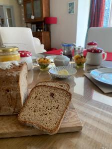 a table with a cutting board with bread on it at La Petite Quinotte in Cadillac