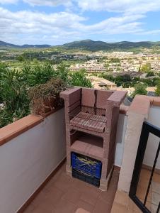 a chair sitting on top of a wall with a view at Casa Orchidea in Villasimius
