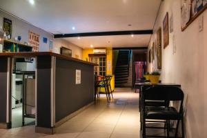a kitchen with a counter and chairs in a room at Soul Hostel Av Paulista Bela Vista 1 in São Paulo