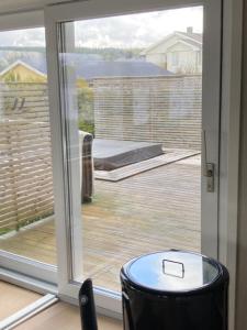 a sliding glass door with a view of a deck at Känslans in Årjäng