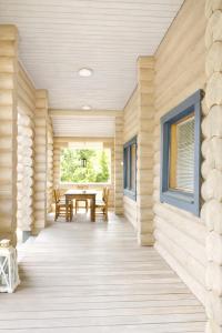 a wooden porch with a table and a window at HIMOS Petäjäkuja 3 in Himos