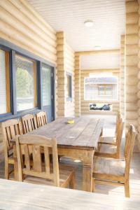 a dining room with a wooden table and chairs at HIMOS Petäjäkuja 3 in Himos