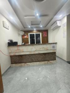 an empty waiting room with a counter in a room at Hotel Blue Neck in Patna