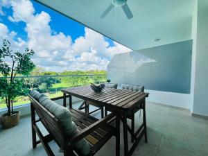a dining room with a table and chairs and a large window at Cana Rock in Punta Cana