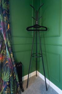 a black stand in a room with a green wall at Casa Sona in Spean Bridge