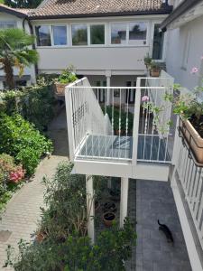 a white staircase in front of a house at Cortile Fiorito Bed and Breakfast mini appartamento in Gorizia