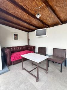 a living room with a couch and a table at Fir Tree Villa in Chişinău