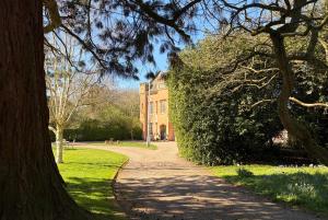 a path in a park with a large building at Bleasby Hall - Kelham Suite B&B in Bleasby +7 photos