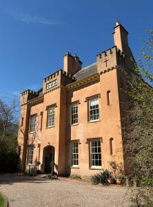 a large brick building with a clock on it at Bleasby Hall - Kelham Suite B&B in Bleasby