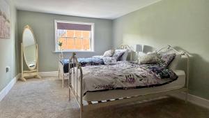 a bedroom with a bed and a window and a mirror at Bleasby Hall - Kelham Suite B&B in Bleasby