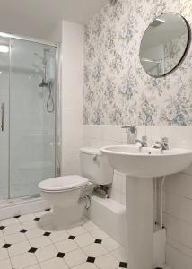a bathroom with a toilet and a sink and a shower at Bleasby Hall - Kelham Suite B&B in Bleasby