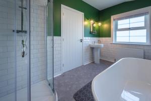 a bathroom with a shower and a toilet and a sink at Casa Sona in Spean Bridge +19 photos