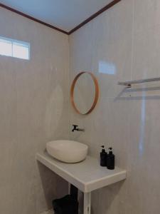 a white bathroom with a sink and a mirror at Batur Tropical in Kintamani +18 photos