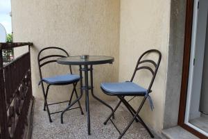 two chairs and a table on a balcony at RelaisApartments PORTO in Alghero +96 photos