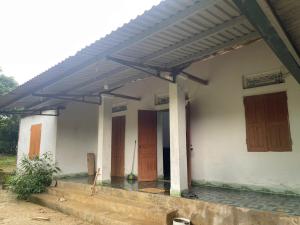 a house with awnings on the side of it at Nhà Đồi 1981 in Lập Liên