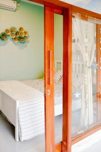 a bedroom with two beds and a window at Unique 2BR Gianyar Villa Rice Field View & Pool in Blahbatu +6 photos