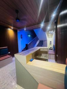 a room with a staircase and a lobby with a counter at Hotel STAYVILLA in Guwahati +34 photos