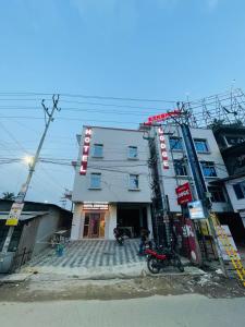 a building with a motorcycle parked in front of it at Hotel STAYVILLA in Guwahati
