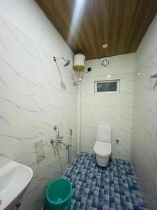 a bathroom with a toilet and a sink at Hotel STAYVILLA in Guwahati