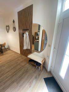 a hallway with a mirror and a bench in a room at Andalics apartment in Kaposvár