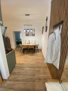 a kitchen and dining room with a table and a dining room at Andalics apartment in Kaposvár