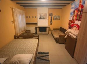 a room with three beds and a fireplace at Greek Hacienda in Nea Kallikrateia