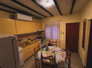 a kitchen with a table and a dining room at Greek Hacienda in Nea Kallikrateia