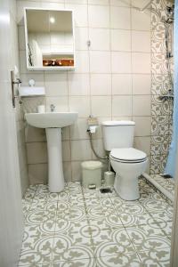 a bathroom with a toilet and a sink at The Nest in Astris +75 photos
