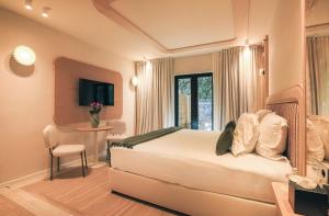 a bedroom with a bed and a desk and a window at Maison Provence in Saint-Tropez +57 photos