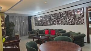 a living room with green couches and red pillows at Alpin Aparthotel Ap 508 Poiana Brasov- acces la piscină gratuit in Poiana Brasov