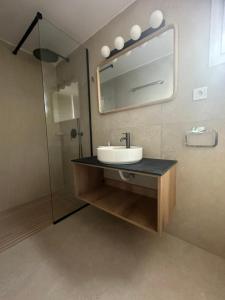 a bathroom with a sink and a mirror at Villa Levanda (Loggos Paxos) in Longós +20 photos
