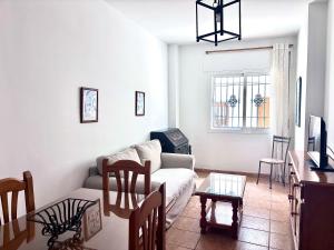 a living room with a couch and a table at Easy Nerja Apartments in Nerja