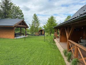 a yard next to a house with a gazebo at Chata Bławatek Kowary in Kowary