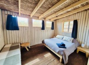 a bedroom with a bed in a wooden room at Casa Luna in Maitencillo