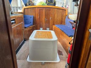 a small boat with a table and seats in it at Romantisk båd nær Kbh in Copenhagen