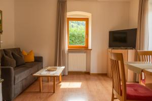 a living room with a couch and a window at Apartments Bernard in Aldino
