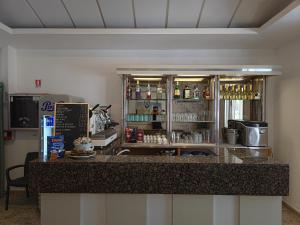 a bar in a restaurant with a counter at Hotel Ornella in Bellaria-Igea Marina