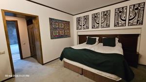 a bedroom with a large bed with green sheets and pillows at Alpin Aparthotel Ap 508 Poiana Brasov- acces la piscină gratuit in Poiana Brasov