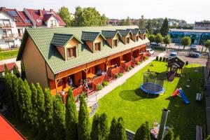 an aerial view of a house with a playground at Dw Perła Sarbinowo in Sarbinowo