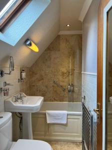 a bathroom with a sink and a shower at Corriegour Lodge Hotel in Spean Bridge +99 photos