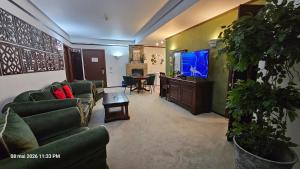 a living room with couches and a tv and a table at Alpin Aparthotel Ap 508 Poiana Brasov- acces la piscină gratuit in Poiana Brasov