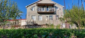 a house with a balcony on the side of it at Comfort Hills in İsmayıllı