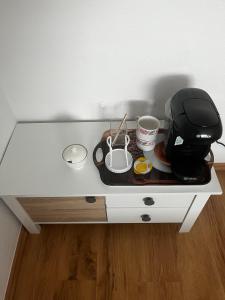 a white table with a coffee maker on it at Ferienwohnung Fatlume No 6 in Bad Honnef am Rhein
