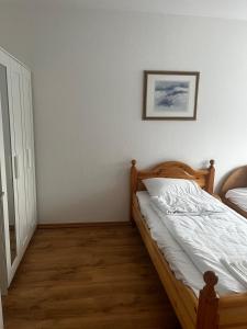 a bedroom with a bed and a picture on the wall at Ferienwohnung Fatlume No 6 in Bad Honnef am Rhein +7 photos