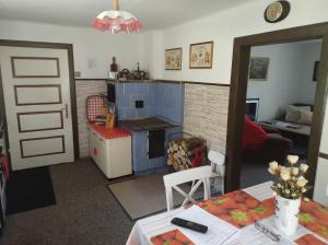 a kitchen and a living room with a table at Chalupa Na Křemence in Třinec