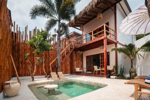 a villa with a swimming pool and a house at The Lost Island- Luxury Private Pool Villas in Gili Trawangan