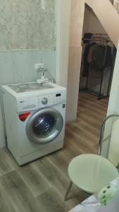 a washing machine sitting on the floor in a room at Котэдж Посуточно in Zhovti Vody